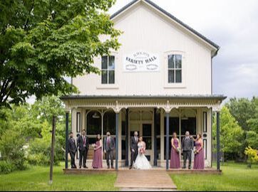 Wedding party in front of a small building in Wismer Commons, Markham, Ontario
