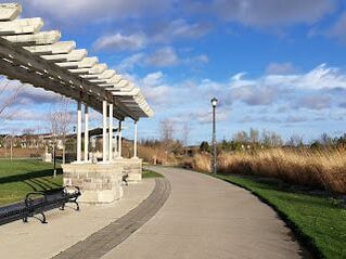 Concrete walkway adjacent to a shelter structure in park in Berczy Village, Markham, Ontario
