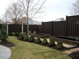 medium brown composite fence in a backyard in Markham, Ontario